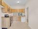 Kitchen with wooden cabinets, tile flooring, and a stainless steel range at 978 Calanda Ave, Orlando, FL 32807