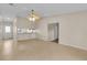 Living room with tiled floor, ceiling fan, and pass-through kitchen counter at 978 Calanda Ave, Orlando, FL 32807