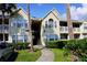 Inviting condo building featuring manicured landscaping, a stairway, and a well-maintained facade under a bright sky at 1031 S Hiawassee Rd # 2514, Orlando, FL 32835