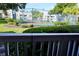 View of a community tennis court with lush landscaping, trees, and neighboring condo buildings in the background at 1031 S Hiawassee Rd # 2514, Orlando, FL 32835