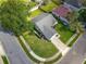 An aerial view of the home, highlighting its corner lot, manicured lawn, and mature trees at 1044 Dees Dr, Oviedo, FL 32765