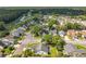 A high aerial view showing the neighborhood with mature trees, streets, and a water feature at 1044 Dees Dr, Oviedo, FL 32765