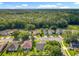 The home is set in a neighborhood surrounded by lush green canopy, an aerial view at 1044 Dees Dr, Oviedo, FL 32765