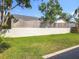 This is a beautiful backyard with lots of green grass and a wall at 1044 Dees Dr, Oviedo, FL 32765