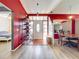 Inviting foyer with red accent wall, tile entryway, glass block feature, and access to the dining area at 1044 Dees Dr, Oviedo, FL 32765