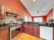 Well-equipped kitchen featuring stainless steel appliances, tiled backsplash, granite countertops and ample cabinetry at 1044 Dees Dr, Oviedo, FL 32765