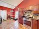 Kitchen boasts stainless steel appliances, granite countertops, tiled floors and overhead lighting at 1044 Dees Dr, Oviedo, FL 32765