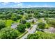 An aerial glimpse of a peaceful neighborhood surrounded by lush greenery and mature trees at 1113 Canopy Oaks Dr, Minneola, FL 34715