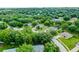Charming aerial perspective of a tree-lined neighborhood featuring well-kept homes and landscaping at 1113 Canopy Oaks Dr, Minneola, FL 34715