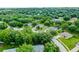 Picturesque aerial view of a residential neighborhood with lush trees and well-maintained yards at 1113 Canopy Oaks Dr, Minneola, FL 34715
