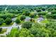An inviting home outlined in red, nestled amongst mature trees in a lush neighborhood at 1113 Canopy Oaks Dr, Minneola, FL 34715