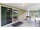 View of a covered patio with sliding glass doors looking out onto the fenced in yard at 1113 Canopy Oaks Dr, Minneola, FL 34715