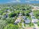 Aerial view of home in yellow square surrounded by lush greenery and nearby amenities at 1310 Oregon St, Orlando, FL 32803