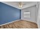 Bedroom with accent wall, wood flooring and ceiling fan at 1310 Oregon St, Orlando, FL 32803
