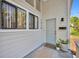 Close-up of front door with modern hardware, house number, and stylish potted plants at 1310 Oregon St, Orlando, FL 32803