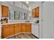 Bright kitchen featuring oak cabinets, white appliances and wood grain flooring at 1310 Oregon St, Orlando, FL 32803