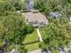 Aerial view showcases a well-maintained property with stone pathway and verdant lawns in a tree-lined neighborhood at 1341 Place Picardy, Winter Park, FL 32789