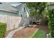 Backyard features a wooden walkway leading to a treehouse, all set on mulch and grass at 1341 Place Picardy, Winter Park, FL 32789