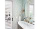 Modern half-bath features designer wallpaper, stylish fixtures, and a window with shutters at 1341 Place Picardy, Winter Park, FL 32789