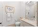 Modern bathroom with a white sink vanity and a framed elephant art piece at 1341 Place Picardy, Winter Park, FL 32789
