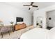 Bedroom includes a desk, vanity, modern ceiling fan, and a view to the bathroom at 1341 Place Picardy, Winter Park, FL 32789
