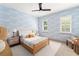 Comfortable bedroom with patterned wallpaper, cozy furniture, and natural light from shuttered windows at 1341 Place Picardy, Winter Park, FL 32789