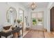 Bright entryway with stylish decor, light hardwood floors, and a view to the front yard at 1341 Place Picardy, Winter Park, FL 32789
