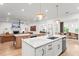 Open kitchen features an island, hardwood floors, and views to the living and dining areas at 1341 Place Picardy, Winter Park, FL 32789