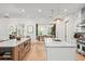 Bright kitchen with double islands, pendant lights, stainless appliances, and hardwood flooring at 1341 Place Picardy, Winter Park, FL 32789