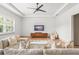Airy living room features a large sectional, area rug, modern fan, and stylish furniture at 1341 Place Picardy, Winter Park, FL 32789