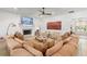 Cozy living room with a large fireplace, plush seating, and bright, neutral decor at 1341 Place Picardy, Winter Park, FL 32789