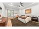 Serene primary bedroom featuring a tray ceiling, ceiling fan, and private balcony access at 1341 Place Picardy, Winter Park, FL 32789