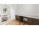 Upstairs office space with built-in desk, cabinets, and modern chandelier lighting at 1341 Place Picardy, Winter Park, FL 32789