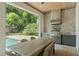 An outdoor kitchen features stainless steel appliances in this home's outdoor entertaining area at 1341 Place Picardy, Winter Park, FL 32789