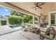 Relaxing covered patio area features comfortable seating, ceiling fans, an outdoor kitchen, and a view of the pool at 1341 Place Picardy, Winter Park, FL 32789
