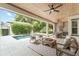 Relaxing covered patio area features comfortable seating, ceiling fans, an outdoor kitchen, and a view of the pool at 1341 Place Picardy, Winter Park, FL 32789