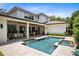 A rectangular pool and spa offer an outdoor oasis at this modern home at 1341 Place Picardy, Winter Park, FL 32789