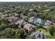 Aerial view of a luxury neighborhood featuring mature landscaping, trees, and tile roofs at 1394 Grove Ter, Winter Park, FL 32789