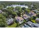 Beautiful aerial view of neighborhood surrounded by a lake and mature landscaping at 1394 Grove Ter, Winter Park, FL 32789