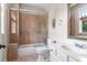 Bathroom featuring tile shower and tub combination with white vanity and sink at 1394 Grove Ter, Winter Park, FL 32789