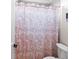 Neutral bathroom featuring tile and shower with a decorative white and orange shower curtain at 1394 Grove Ter, Winter Park, FL 32789