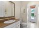 Bright bathroom featuring a granite countertop vanity and direct access to outdoor scenery at 1394 Grove Ter, Winter Park, FL 32789