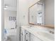 Bright bathroom with a dual vanity, large mirror, and access to another bedroom at 1394 Grove Ter, Winter Park, FL 32789