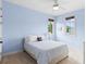 Comfortable bedroom with natural light, a ceiling fan, and blue accent walls at 1394 Grove Ter, Winter Park, FL 32789