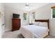 Inviting bedroom with natural light, a wood dresser, and comfortable bed at 1394 Grove Ter, Winter Park, FL 32789