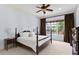 Calm bedroom with a ceiling fan, neutral tones, and natural light from a large window at 1394 Grove Ter, Winter Park, FL 32789