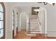 Sun-filled entryway boasts wood floors, an arched doorway and a staircase with wrought iron spindles at 1394 Grove Ter, Winter Park, FL 32789
