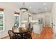 Well-lit eat-in kitchen with white cabinetry, stainless steel appliances, and charming breakfast nook at 1394 Grove Ter, Winter Park, FL 32789