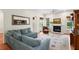 Inviting living room with fireplace, plush sofa, and view of the backyard at 1394 Grove Ter, Winter Park, FL 32789