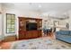 Cozy living room featuring custom entertainment center and an open floor plan to the kitchen at 1394 Grove Ter, Winter Park, FL 32789